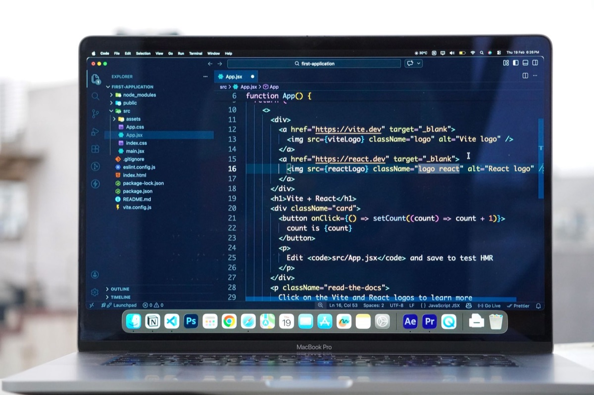 Laptop with code editor open in modern office