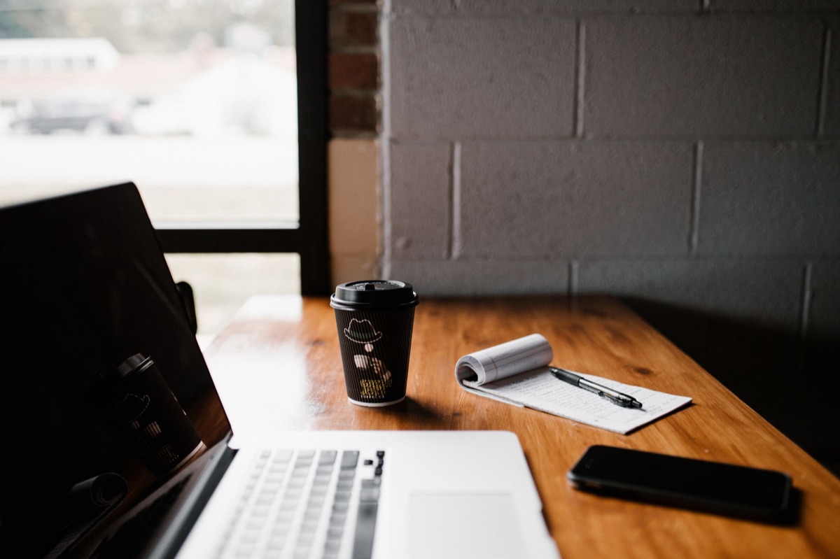 Clean, organized small business office with CRM tools and documents