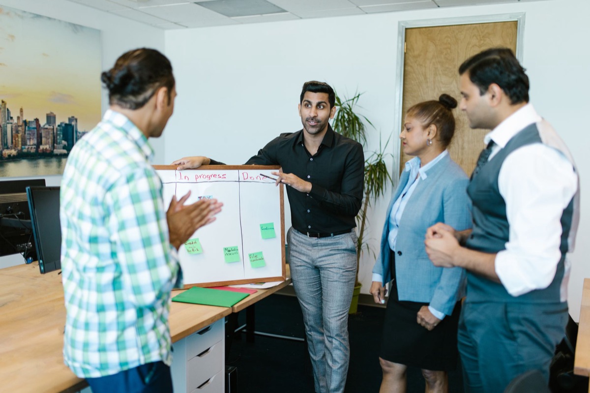 Asana team collaboration board with sticky notes and digital cards