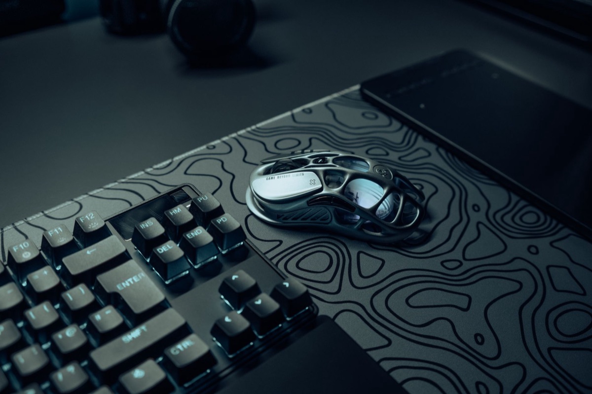 mão segurando mouse e teclado ergonômico